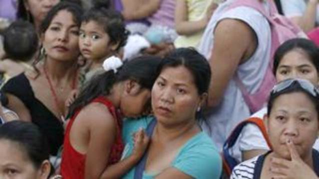 Foreign worker mother in Israel holds her daughter.